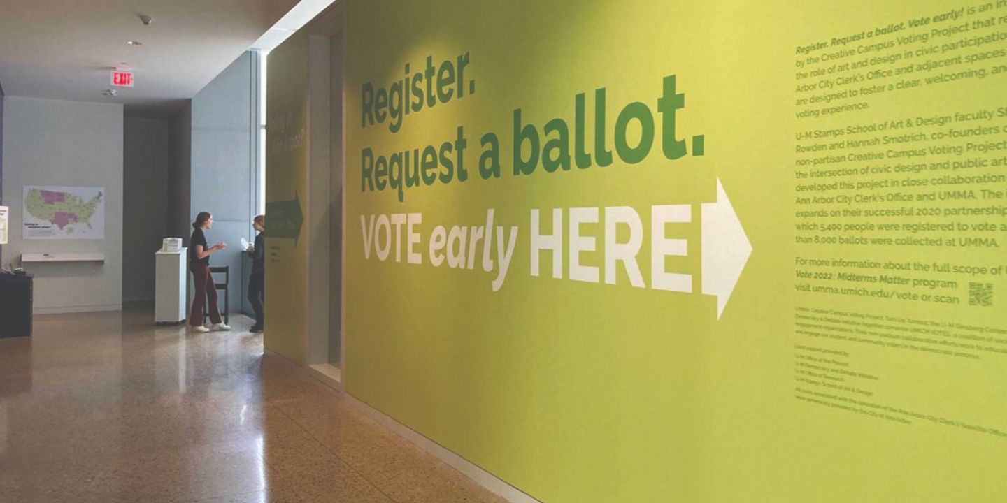 A wall of a Campus Voting Hub with the words "Register. Request a ballot. Vote early here" painted on it