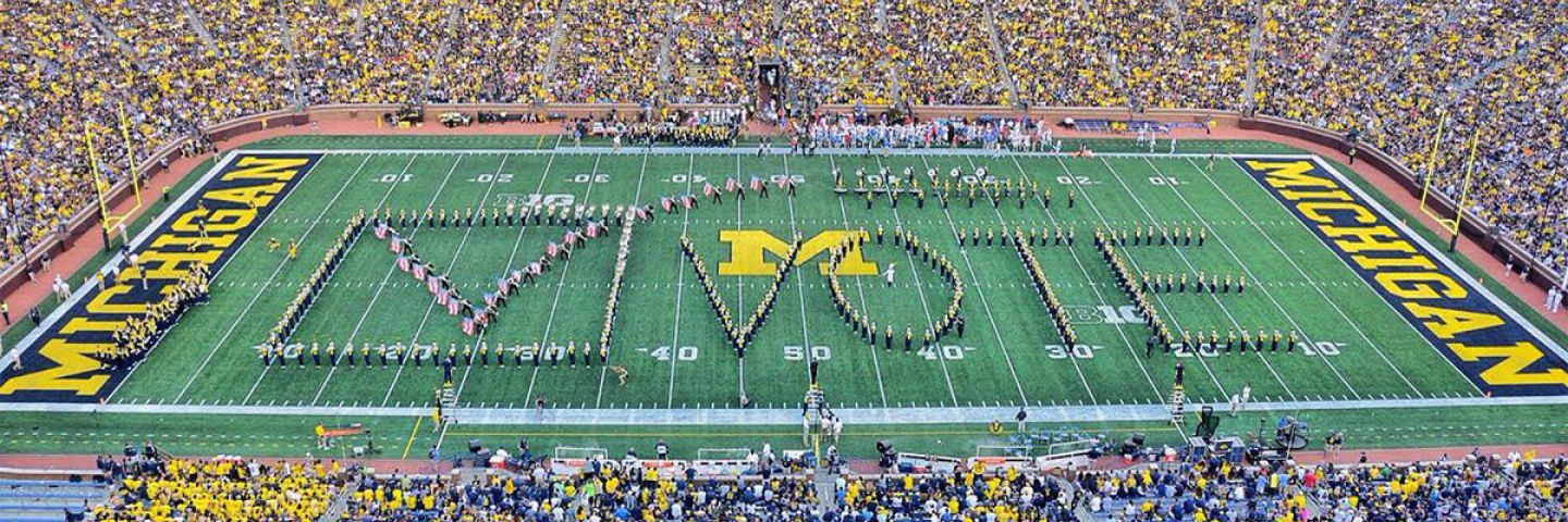 The Michigan Marching Band in formation spelling Vote on the field of the Big House